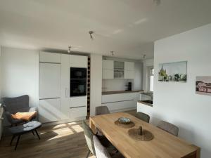 a kitchen and dining room with a table and chairs at Haus Fährblick in Rees
