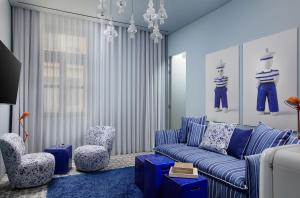 a living room with a blue couch and chairs at Fresh Hotel, a member of Design Hotels in Athens