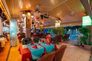 a restaurant with blue and red tables and chairs at Side Orientt Apartments in Side