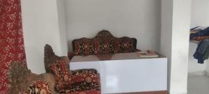 a room with a chair and a table with a book at Hotel & Bothgaya Waterpark in Bodh Gaya