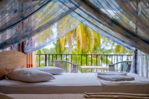 a bedroom with a bed in a tent at Lake Edge Resort in Hambantota