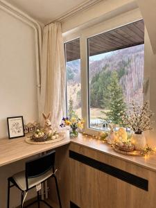 a kitchen counter with a window with christmas decorations at Apartman48Brzeće in Brzeće