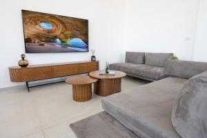 a living room with a couch and a table at רויאל טווינס בוטיק in Safed