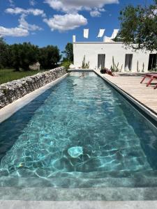 a person swimming in a swimming pool at Masseria Noja in Noci