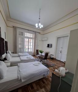 a large room with three beds and a table at Dawn town palace in Cairo