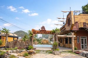 an entrance to a resort with a swimming pool at Hung Long Harbour Hotel in Cat Ba