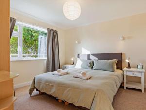 a bedroom with a bed with two towels on it at 2 Bed in Bude oc-87225 in Kilkhampton