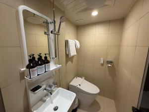 a small bathroom with a toilet and a sink at Latree Hotel in Seoul +19 photos