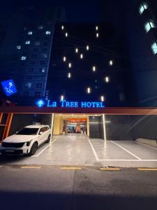 a white car parked in front of a la tree hotel at Latree Hotel in Seoul