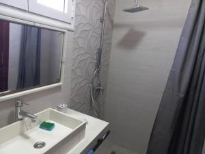 a bathroom with a sink and a shower at Dar Zina in Mteurch