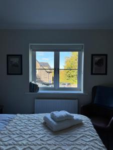 a bedroom with a bed and a window at Marie House in Bowness-on-Windermere