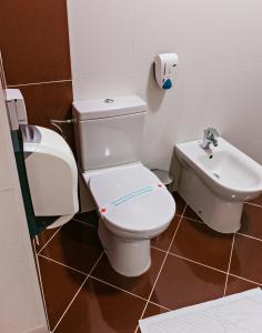 a bathroom with a toilet and a sink at Hotel San Terme Laktaši in Laktaši