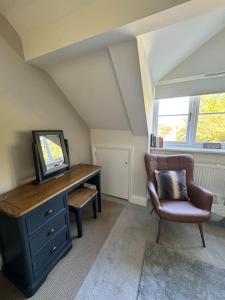 a attic room with a desk and a chair at Marie House in Bowness-on-Windermere