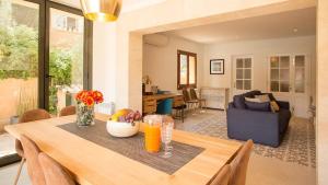 a dining room with a table and a living room at Mallorca Soller Port Villa High end Balearics in Port de Soller