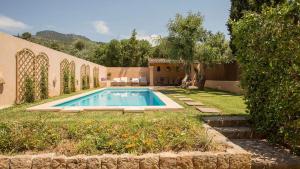 a swimming pool in the yard of a house at Mallorca Soller Port Villa High end Balearics in Port de Soller