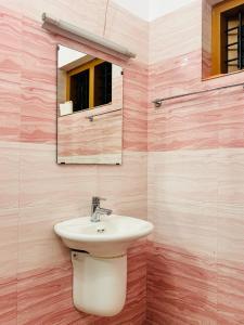 a bathroom with a sink and a mirror at Rare Rabbit Munnar in Anachal +24 photos