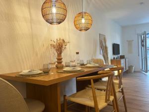 a dining room with a table with chairs and lights at MurgLoge Gaggenau in Gaggenau