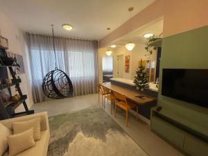 a living room with a kitchen and a dining room at Incrível apto com banheira e garagem perto de tudo in Florianópolis