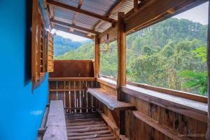 a room with a window with a view of the mountains at Joan's All Seasons Homestay in Taccon
