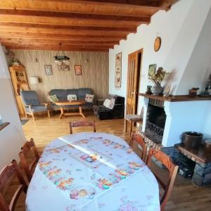 a living room with a table and a fireplace at Wypoczynek Kocia Góra in Dziemiany