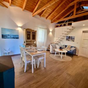 a kitchen and living room with a table and chairs at The House of Waves in Kotrónion +24 photos