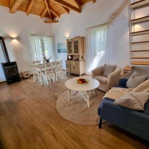 a living room with a couch and a table at The House of Waves in Kotrónion