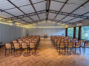 a large room with rows of chairs and tables at Aspen Riverside Resort in Rishīkesh +119 photos