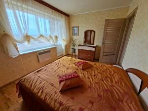 a bedroom with a large bed and a window at Prie Masčio ežero in Telšiai
