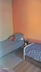 two beds sitting next to each other in a room at Arijaana Guest Studio in Gunjur
