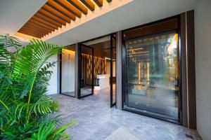 an external view of a house with sliding glass doors at S Resort El Nido Managed by H Hospitality Group - Newly Renovated in El Nido