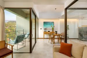 a living room with a table and chairs and a dining room at The Loft Mirissa in Mirissa