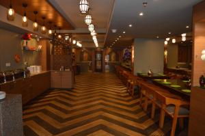 a restaurant with wooden floors and wooden tables and chairs at Hotel Namo Residency in Vijayawāda