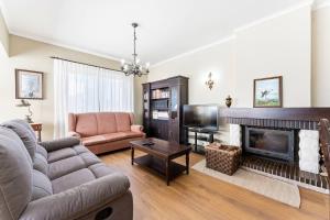 a living room with a couch and a fireplace at Casa da Betinha in Ílhavo
