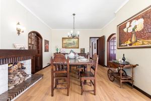 a dining room with a table and a fireplace at Casa da Betinha in Ílhavo