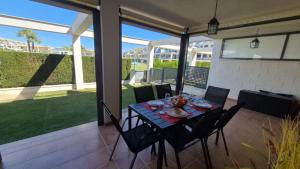 a dining table and chairs on a patio at Panoràmic Vinaros in Sant Jordi