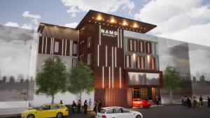 a rendering of a building with cars parked in front at Hotel Namo Residency in Vijayawāda