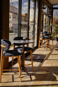 a table and chairs sitting in front of a store at Hôtel Restaurant Atrachjata in Aléria