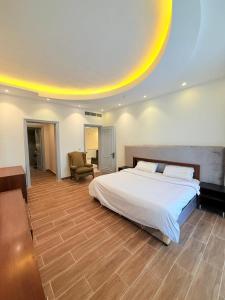 a large bedroom with a bed and a chair at فلة درة العروس in Jeddah +17 photos