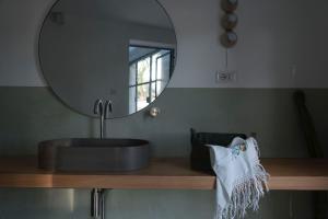 a bathroom with a sink and a mirror at Masseria Noja in Noci