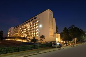 a large white building at night with lights at Keys Prima by Lemon Tree Hotels, Whitefield, Bengaluru in Bangalore