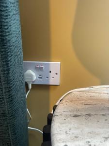 a corner of a room with a phone on a wall at Seaside Suite Quilty in Quilty