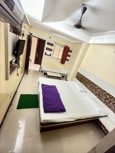 a hospital room with a bed and a tv at hotel bhagwati patel bright in Indore