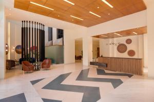 a lobby with a geometric pattern on the floor at Keys Prima by Lemon Tree Hotels, Whitefield, Bengaluru in Bangalore +77 photos