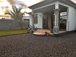 a white house with a porch and a driveway at cozy home in Argy
