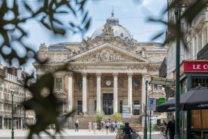 a large building with people walking in front of it at Le Catherine by Sweett in Brussels