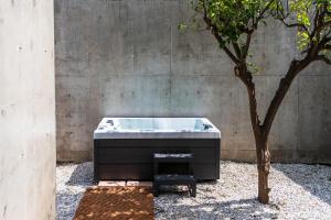 a bath tub sitting next to a tree at Villa 7 in Perivólia