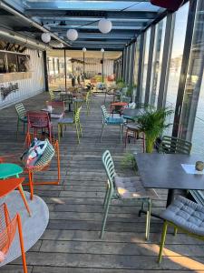 a patio with tables and chairs on a deck at Sundeck botel - party boat in Bratislava