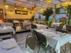 a restaurant with white tables and chairs in a room at Hotel Zurich Oldtown in Antalya
