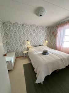 a bedroom with a large bed and a window at Sunshine Stuga Mörtsjön in Stugun