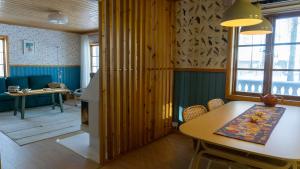 a living room with a table and a dining room at Sunshine Stuga Mörtsjön in Stugun +71 photos